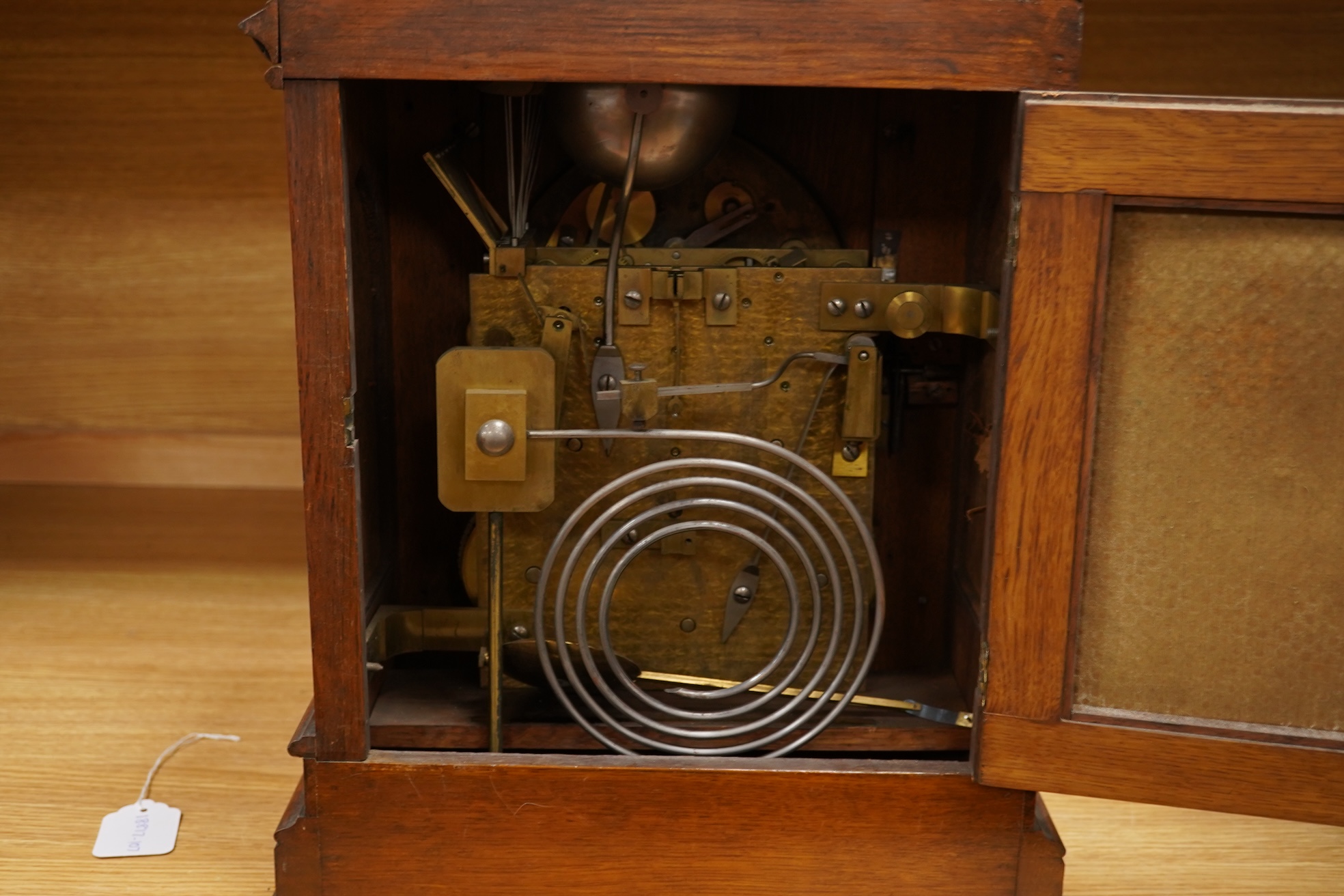 A German Gothic style oak mantel clock, early 20th century, with pendulum and keys, 49cm high